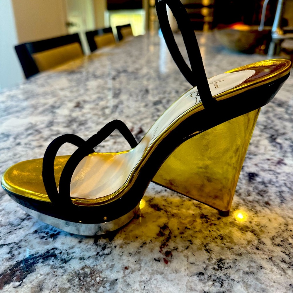 Gold Christian Louboutin wedges w/black suede straps.